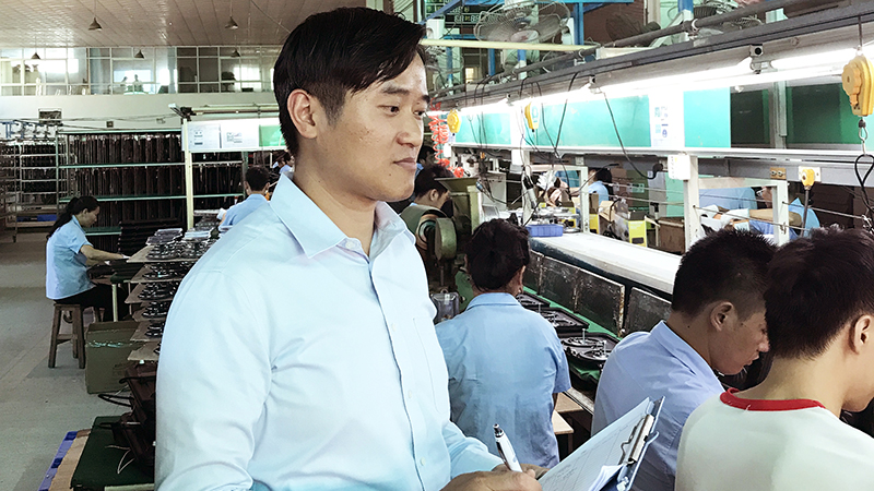 Lewis Chow, an ethical sourcing manager for WBA Global Brands Asia, conducts an inspection at one of the facilities that manufactures WBA owned-brand products.