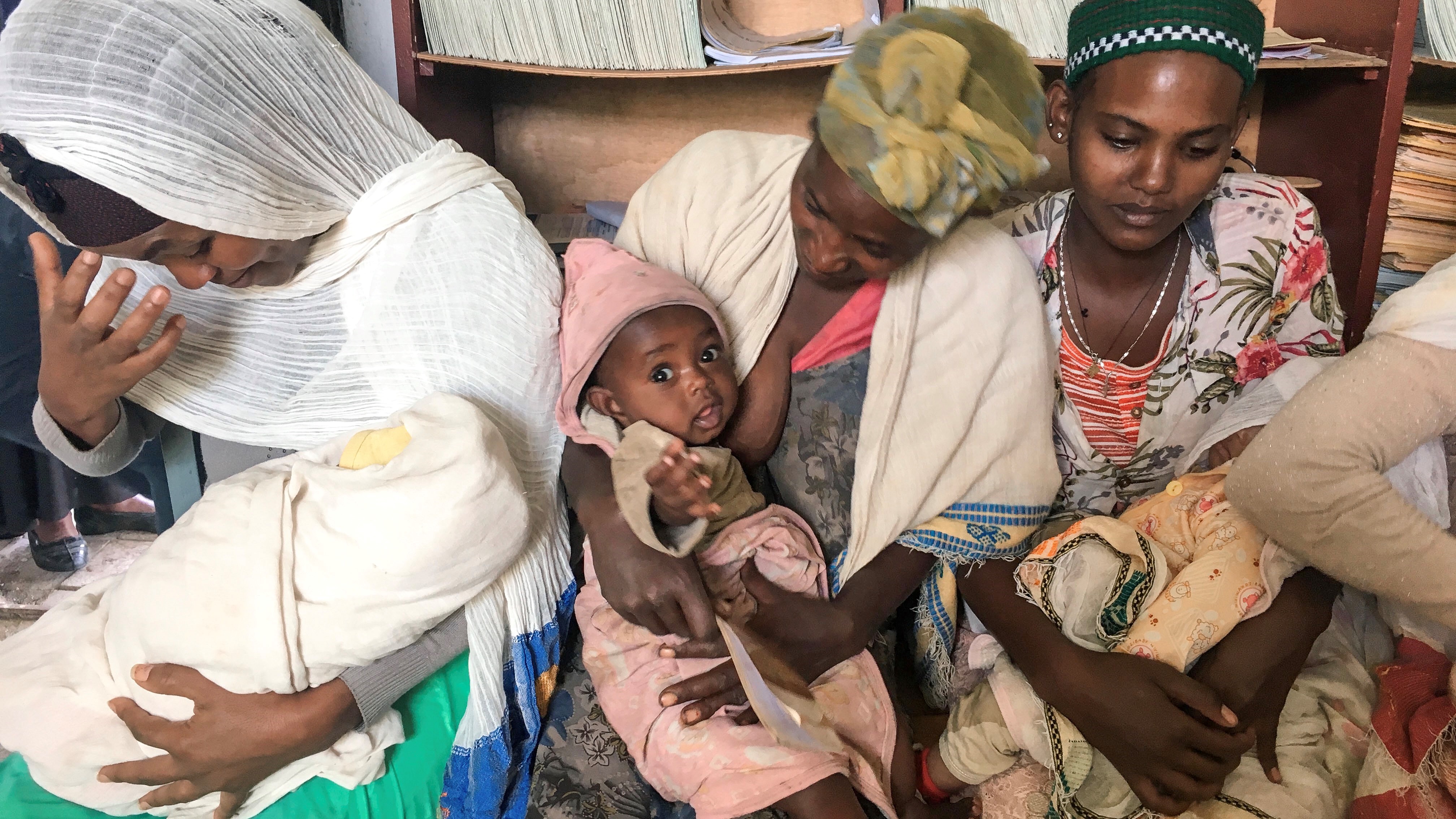 Moms and babies waiting at vaccine post