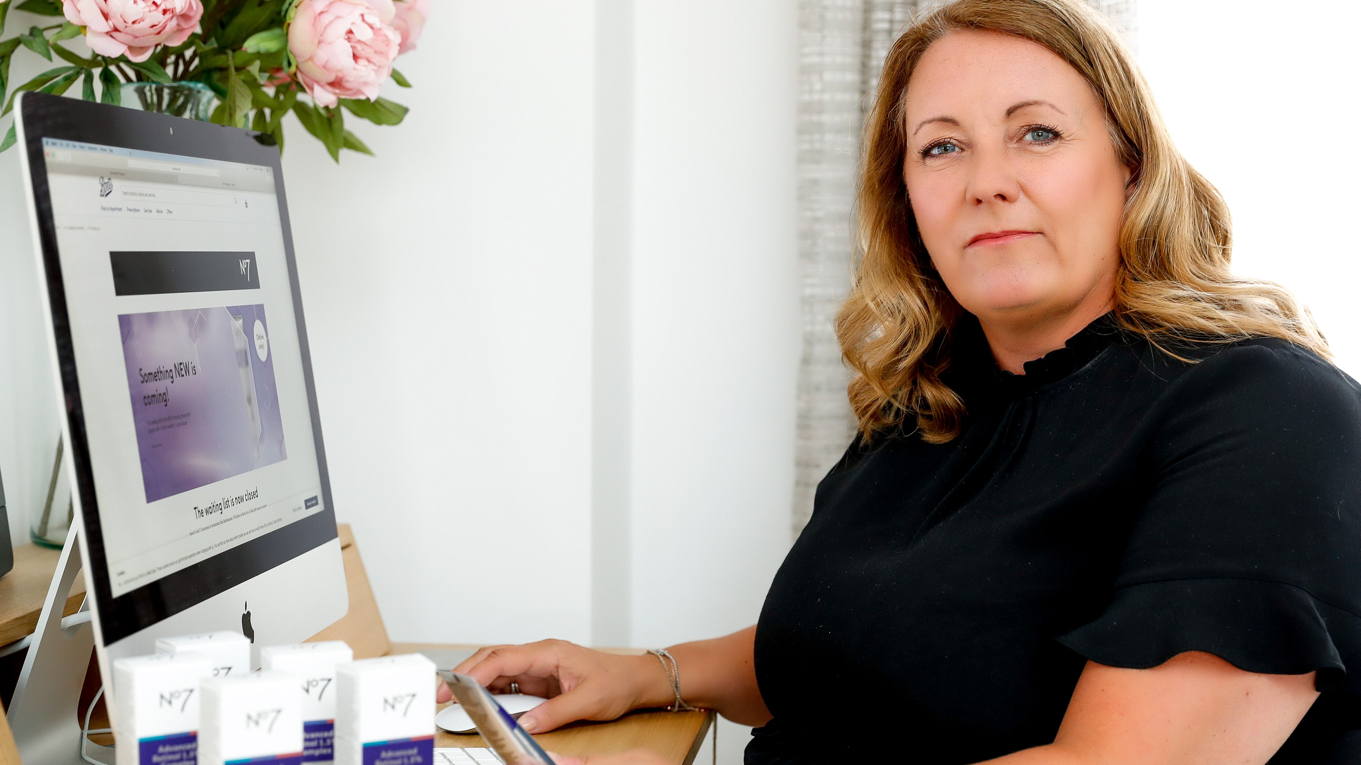 Annie Murphy sitting at her computer