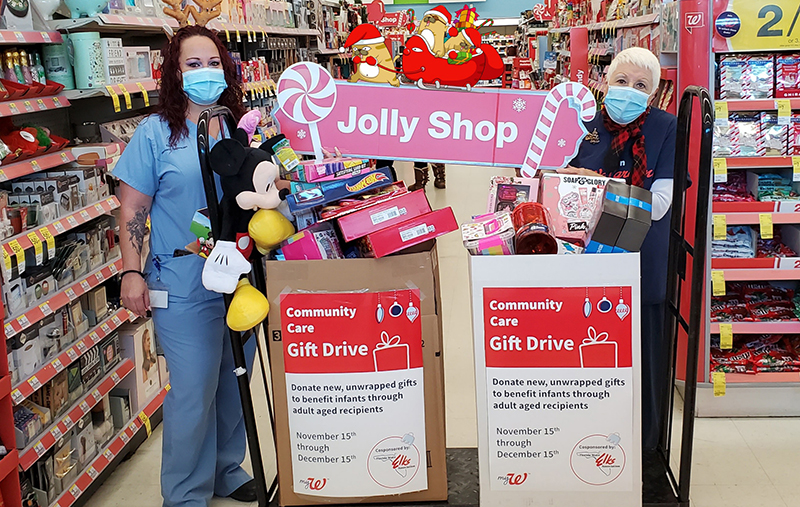 Senior pharmacy technician Eva McGinnis (left) and Cecilia Adam pose with toys donated at the Walgreens in Tarpon Springs, Fla.