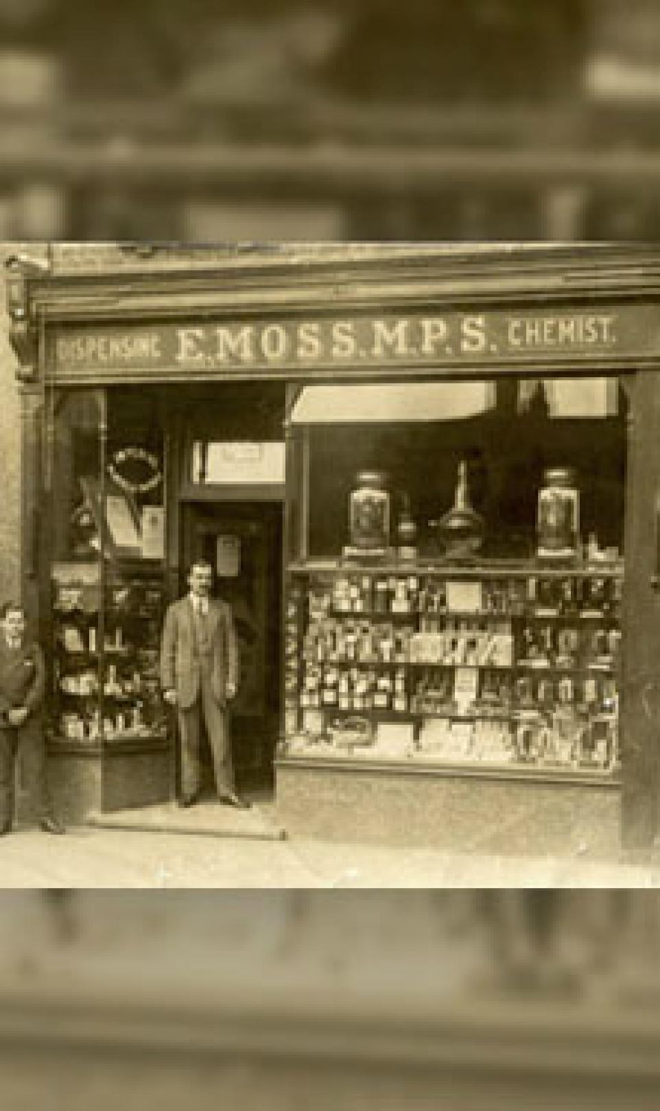 Photo of Edgar Moss outside of his first Moss Chemists store in Middlesex, UK