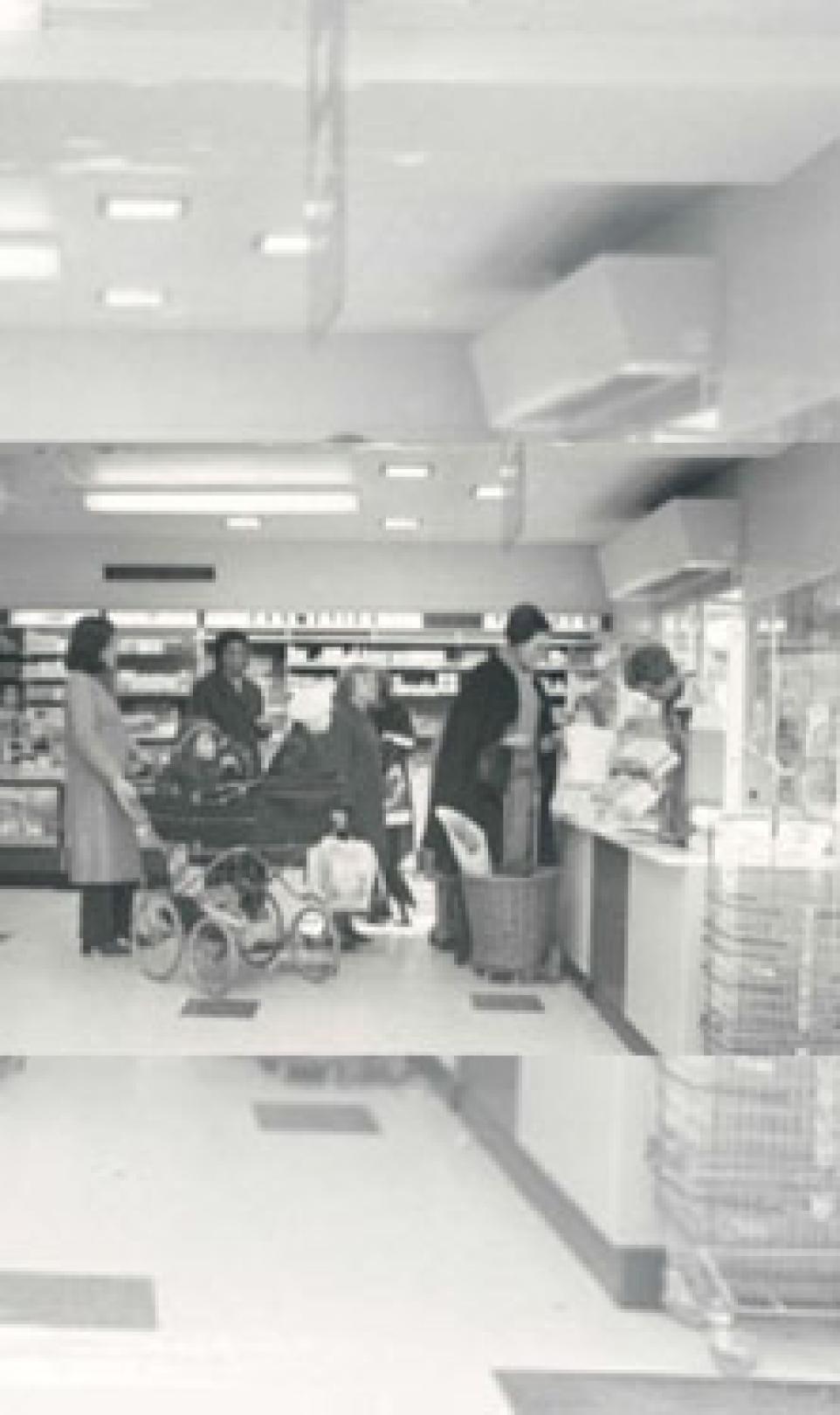 Black and white photograph, inside of the first self-service Boots store in London, UK.