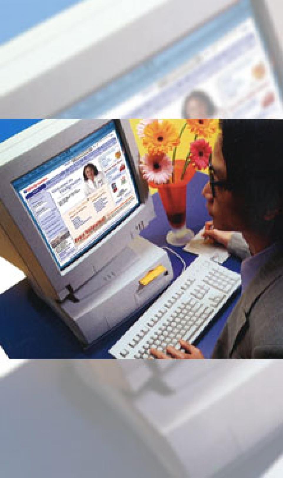 A woman using a 90's computer to access the Walgreens.com online pharmacy
