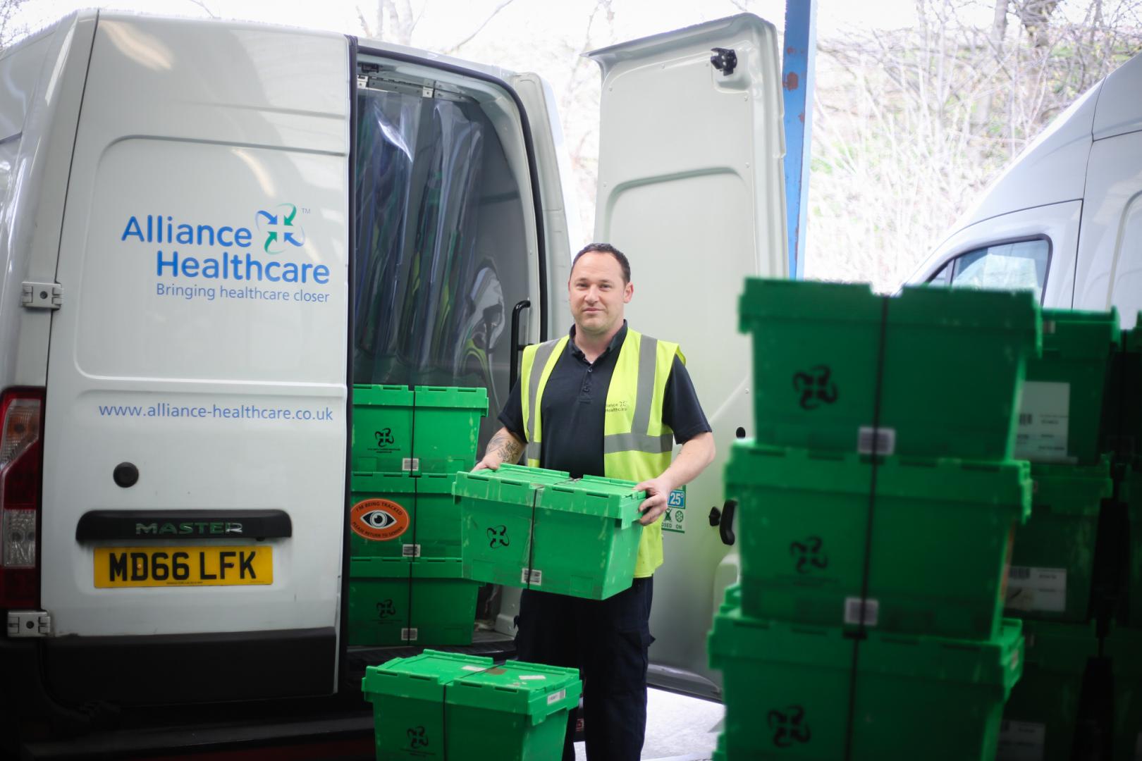 Man loading an Alliance Healthcare delivery van