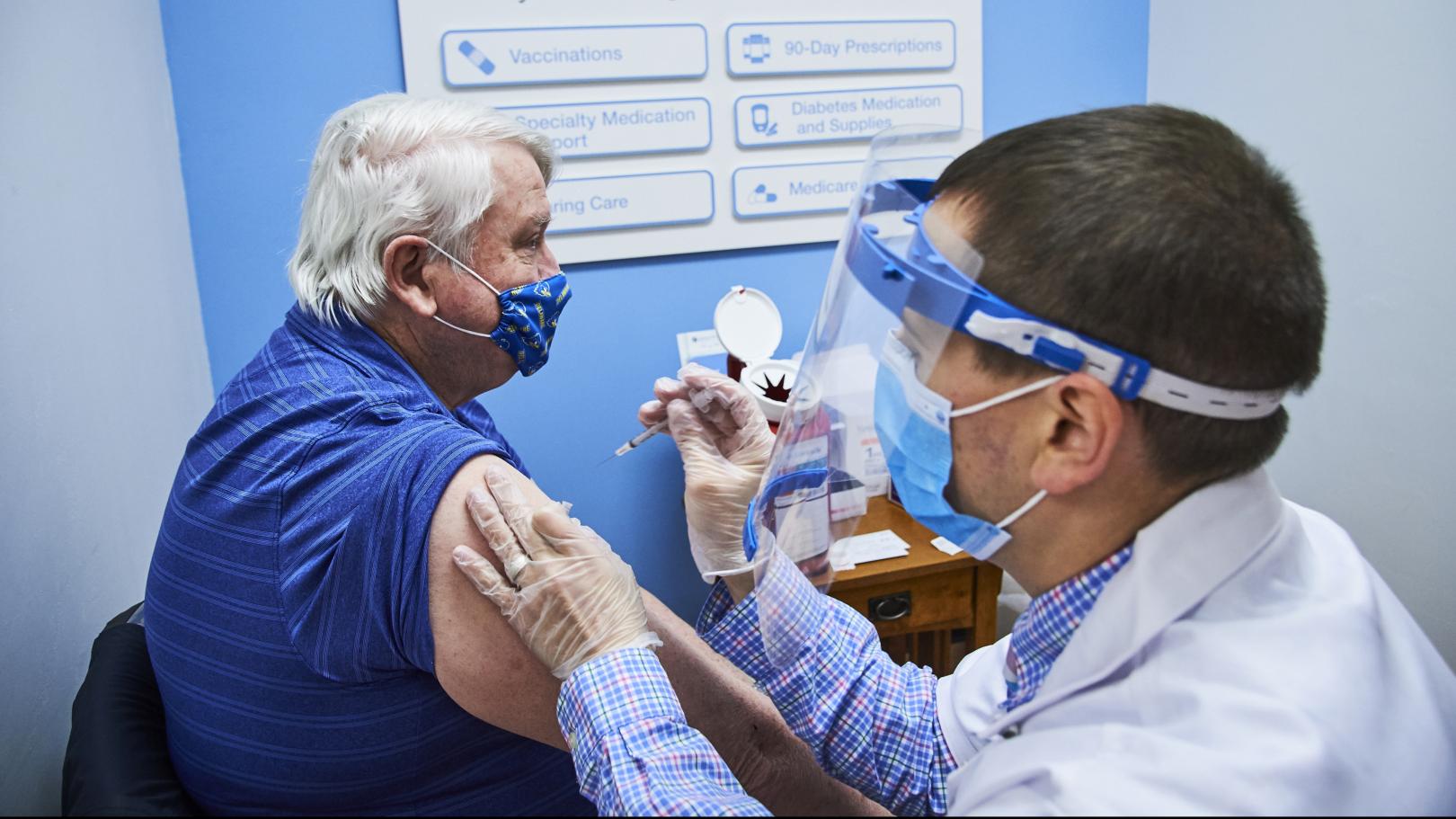 Walgreens team member administering a COVID-19 vaccination.