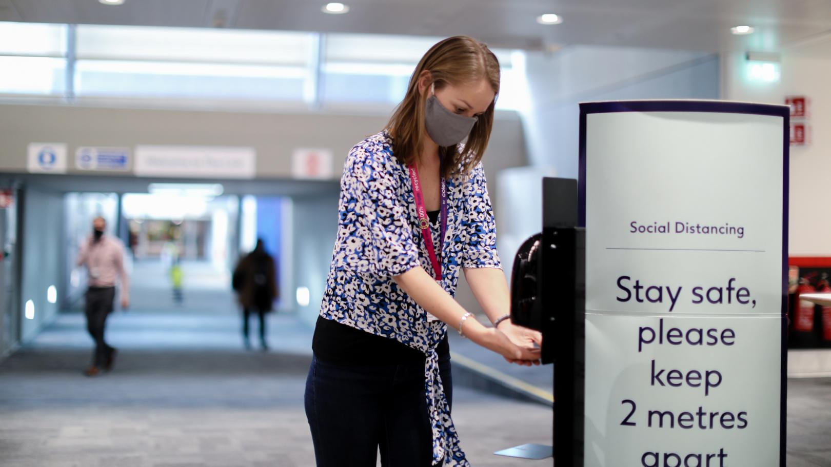 Team member using a hand sanitiser at Boots Netherfield office