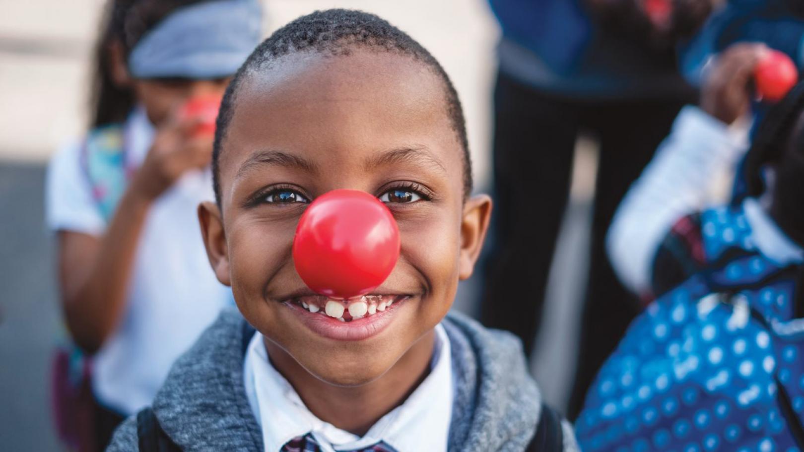 Child wearing a Red Nose Day red nose.