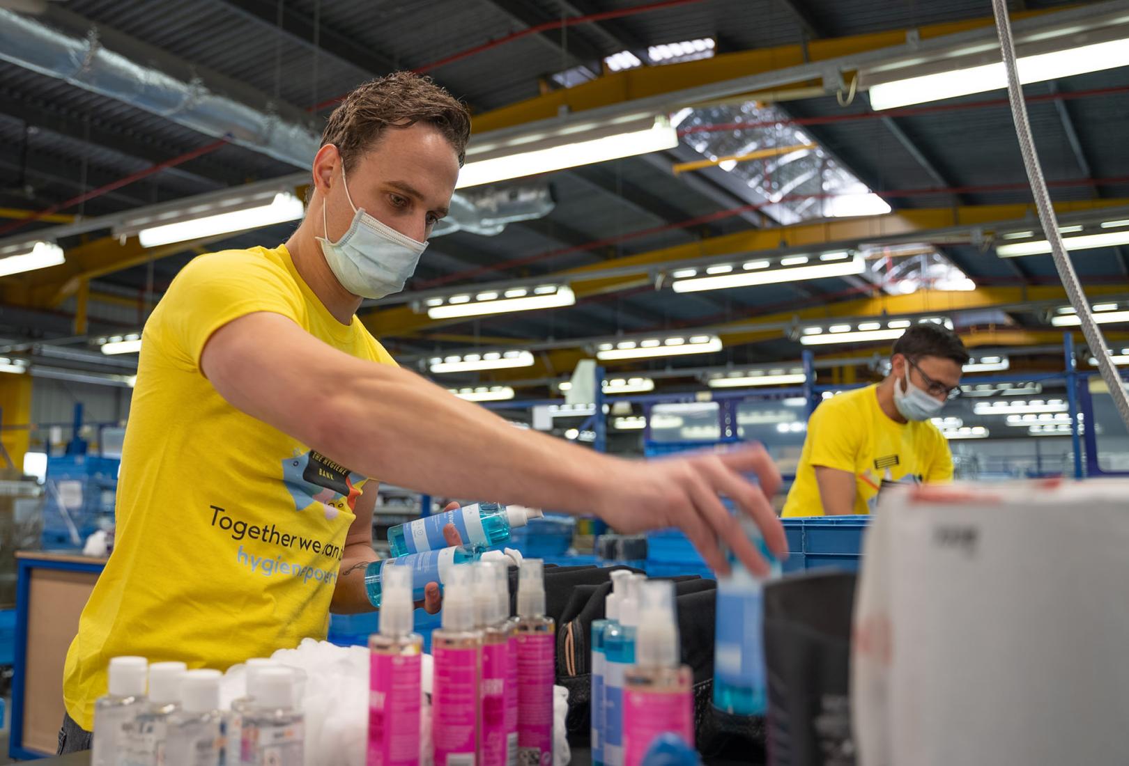 Team members packing product donations for charity partner The Hygiene Bank in the UK