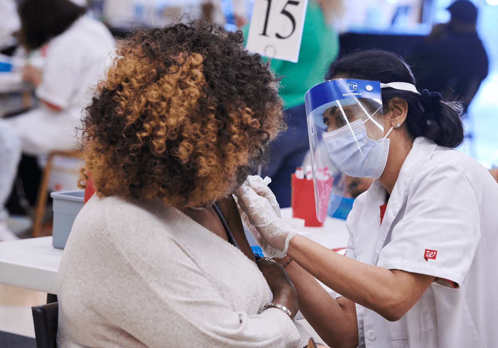 Walgreens team member administering a COVID 19 vaccination