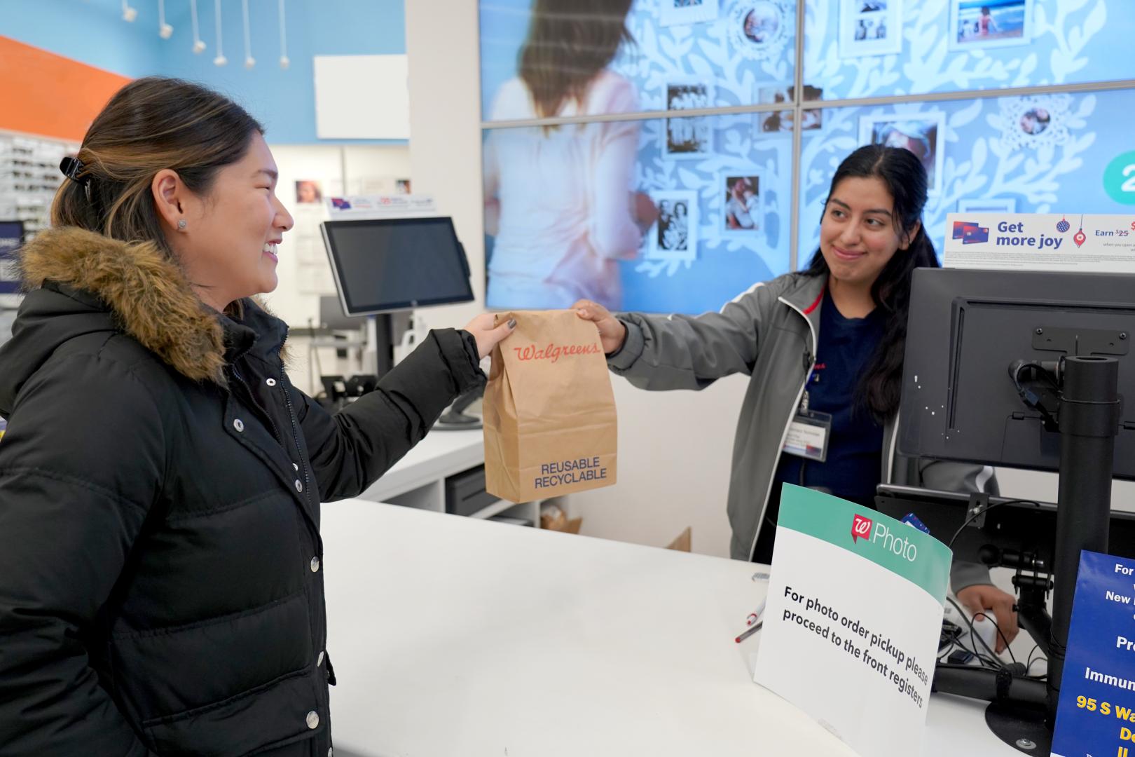 A courier picks up a 24Hour Same Delivery order from Walgreens
