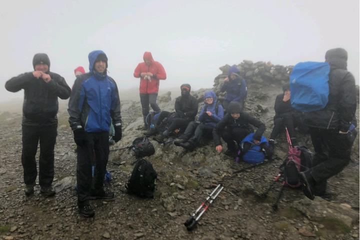 Walkers taking a break in poor conditions on the Wainwright summits in the UK