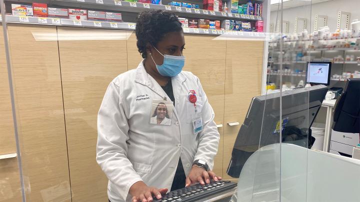 Joynell Bean working the pharmacy counter