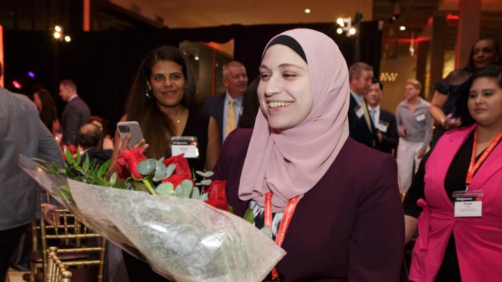 Team memeber Ahlam Antar holding flowers after winning an award