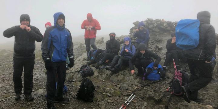 Walkers taking a break in poor conditions on the Wainwright summits in the UK