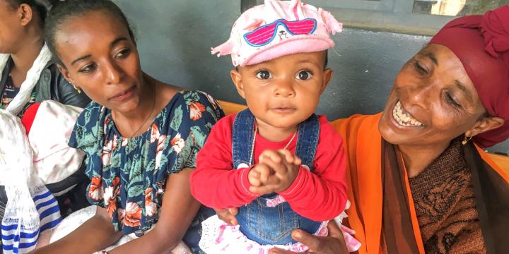 Mother and baby sitting outside clinic in Ethiopia 