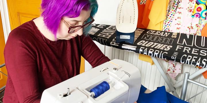 Elise at sewing machine making face masks
