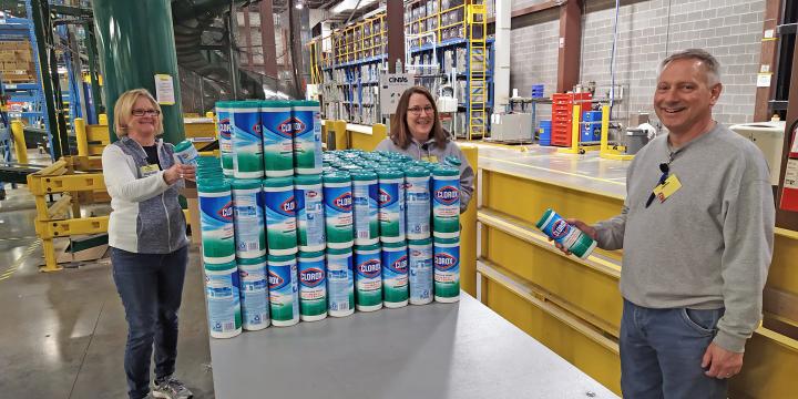Workers at U.S. distribution center smiling at the camera