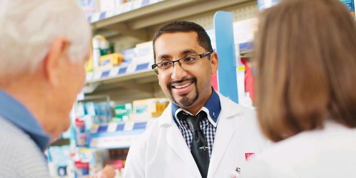 Walgreens Pharmacist with two Patients