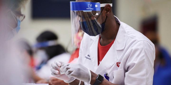 Walgreens pharmacist administers vaccine