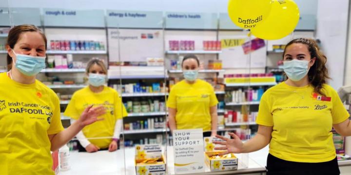 Employees holding balloons for Daffodil Day.