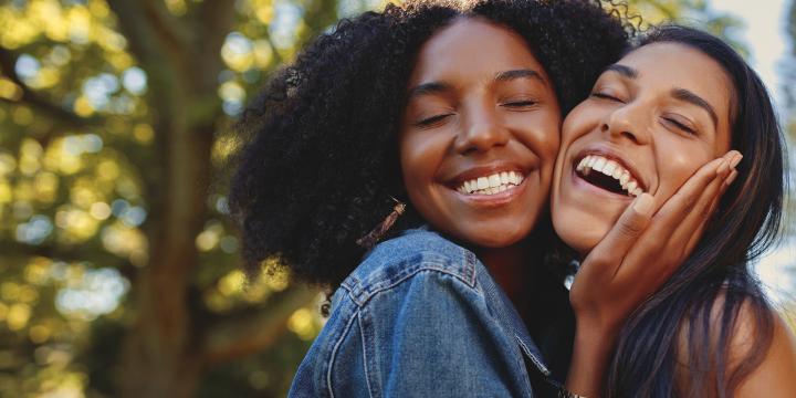 Two women hugging and smiling
