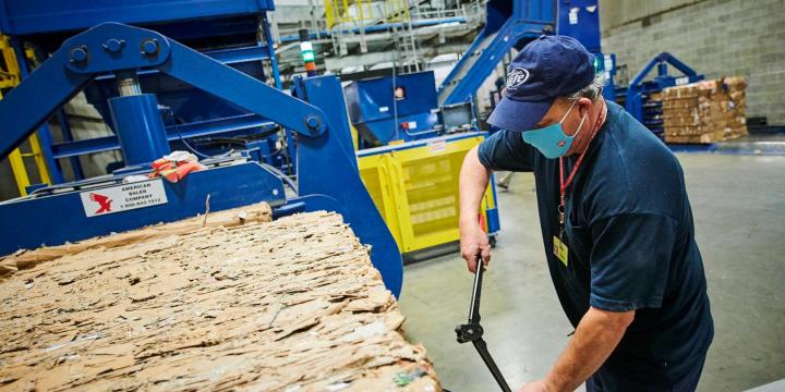 a man recycling paper waste