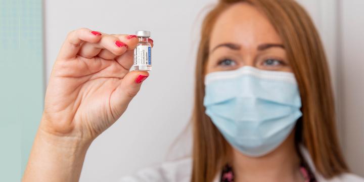 Pharmacist holding phial of Janssen COVID-19 vaccine