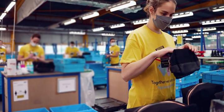 Woman packing products into wash bag