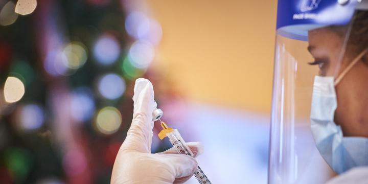 WBA pharmacist holding vaccine