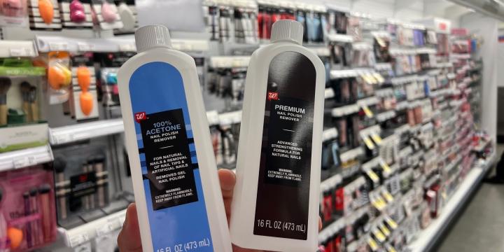 Two bottles of nail polish remover in a customer's hand