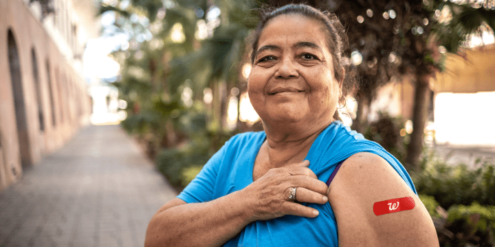 Woman showing Walgreens bandaid on arm