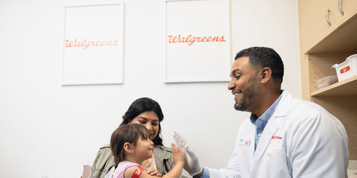 Young patient high-fives pharmacist after vaccination