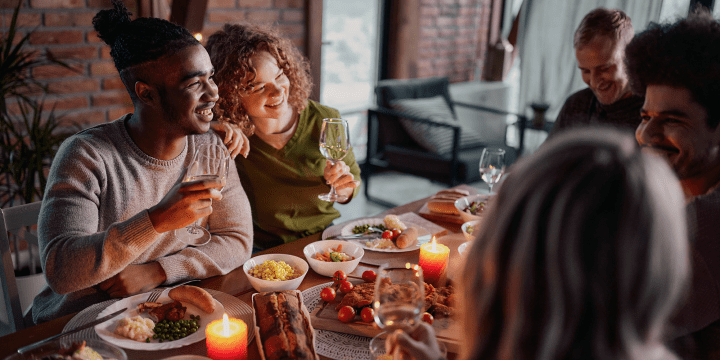 Family and friends enjoying a meal at the dinner table during the holidays