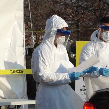 Workers at a drive thru testing facility