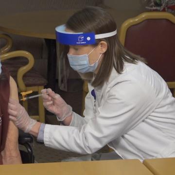 Kate Latta vaccinates a patient